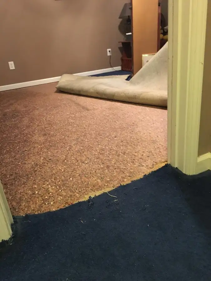 Carpet pad removal revealing water damage during Water Mitigation Services in San Jose